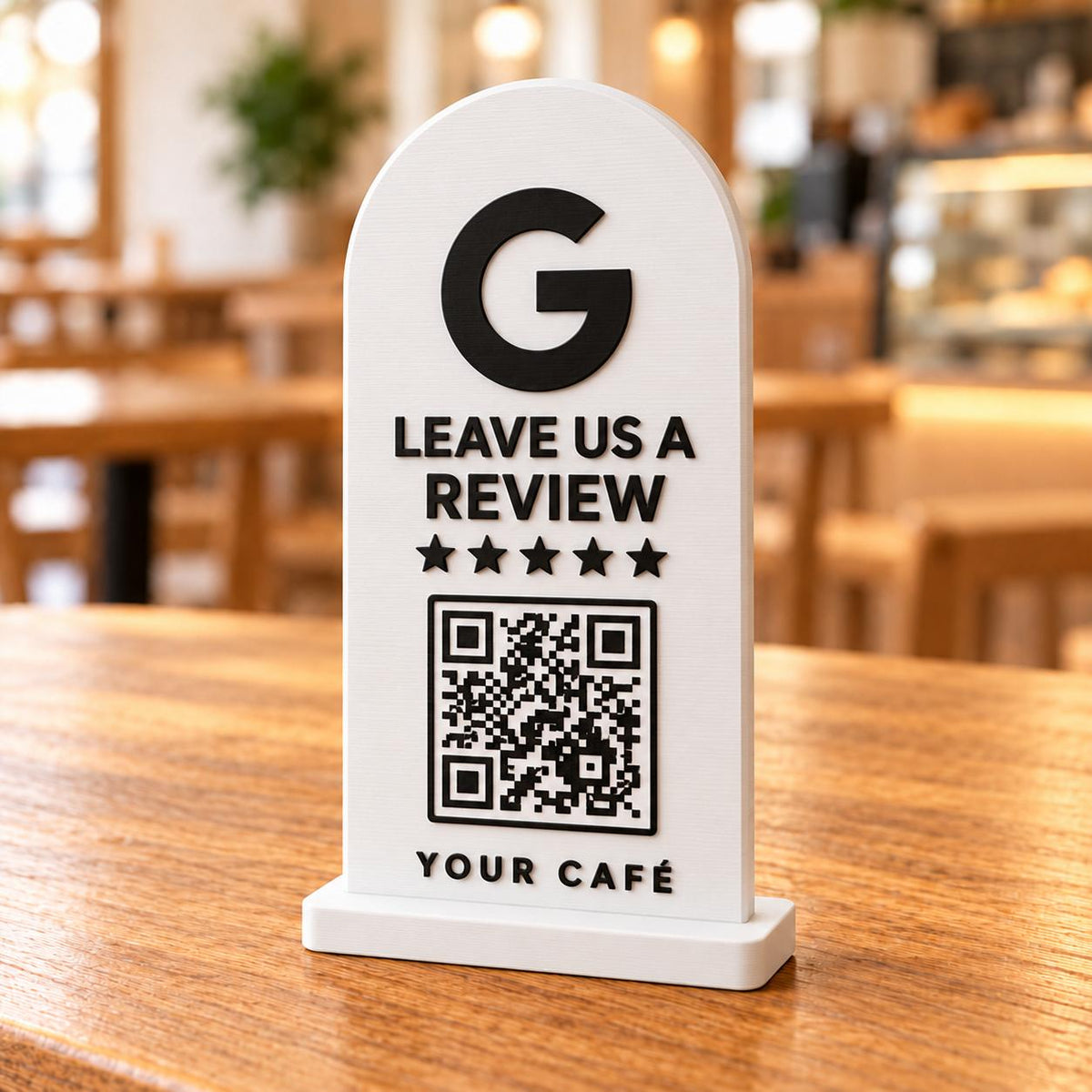 White 3D printed Google review stand with QR code and five stars on a café table
