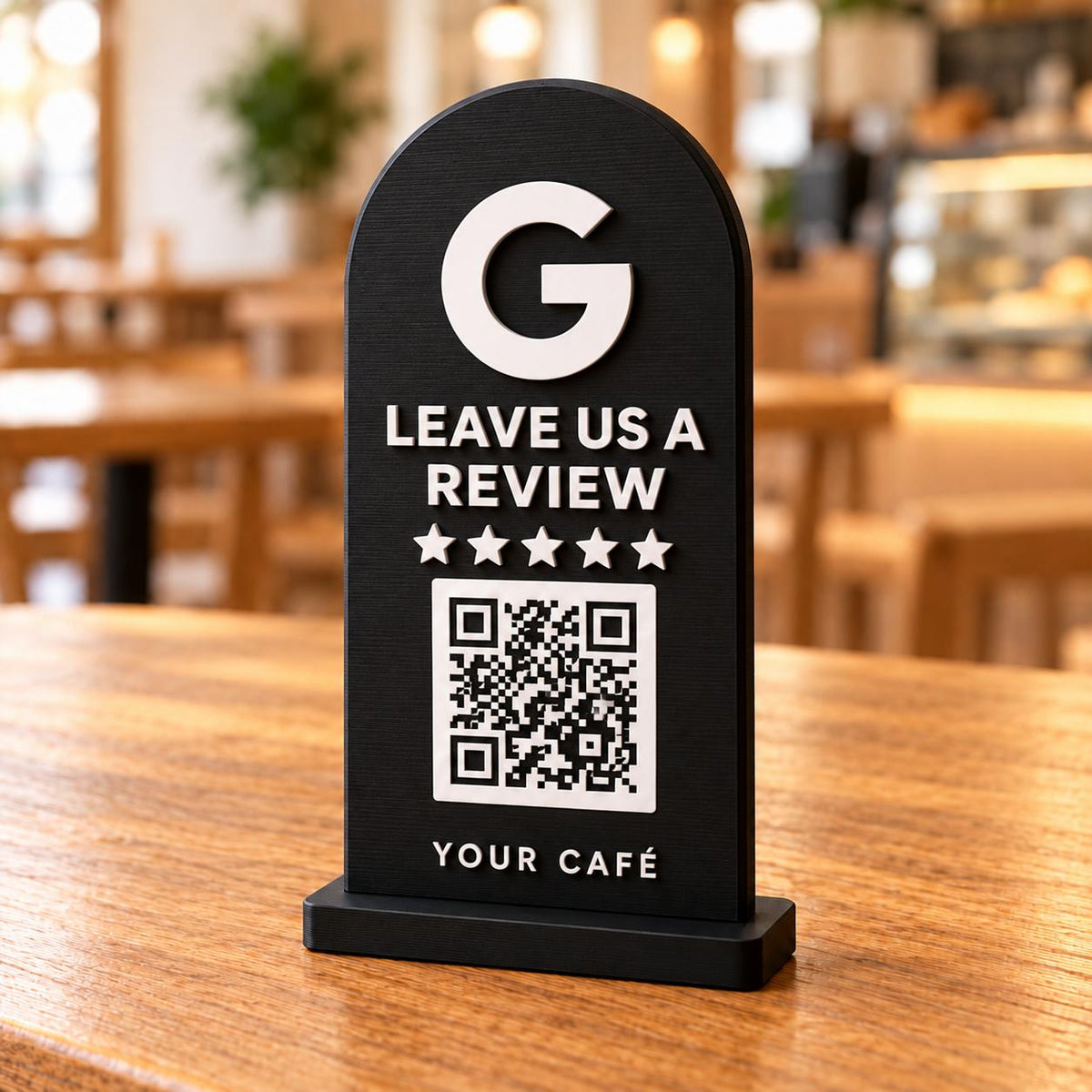 Black 3D printed Google review stand with QR code and five stars on a café table