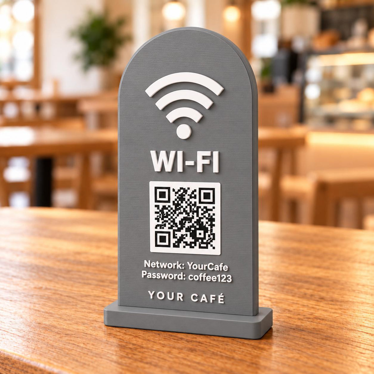 Grey 3D printed café Wi-Fi sign with QR code and network details on a wooden table